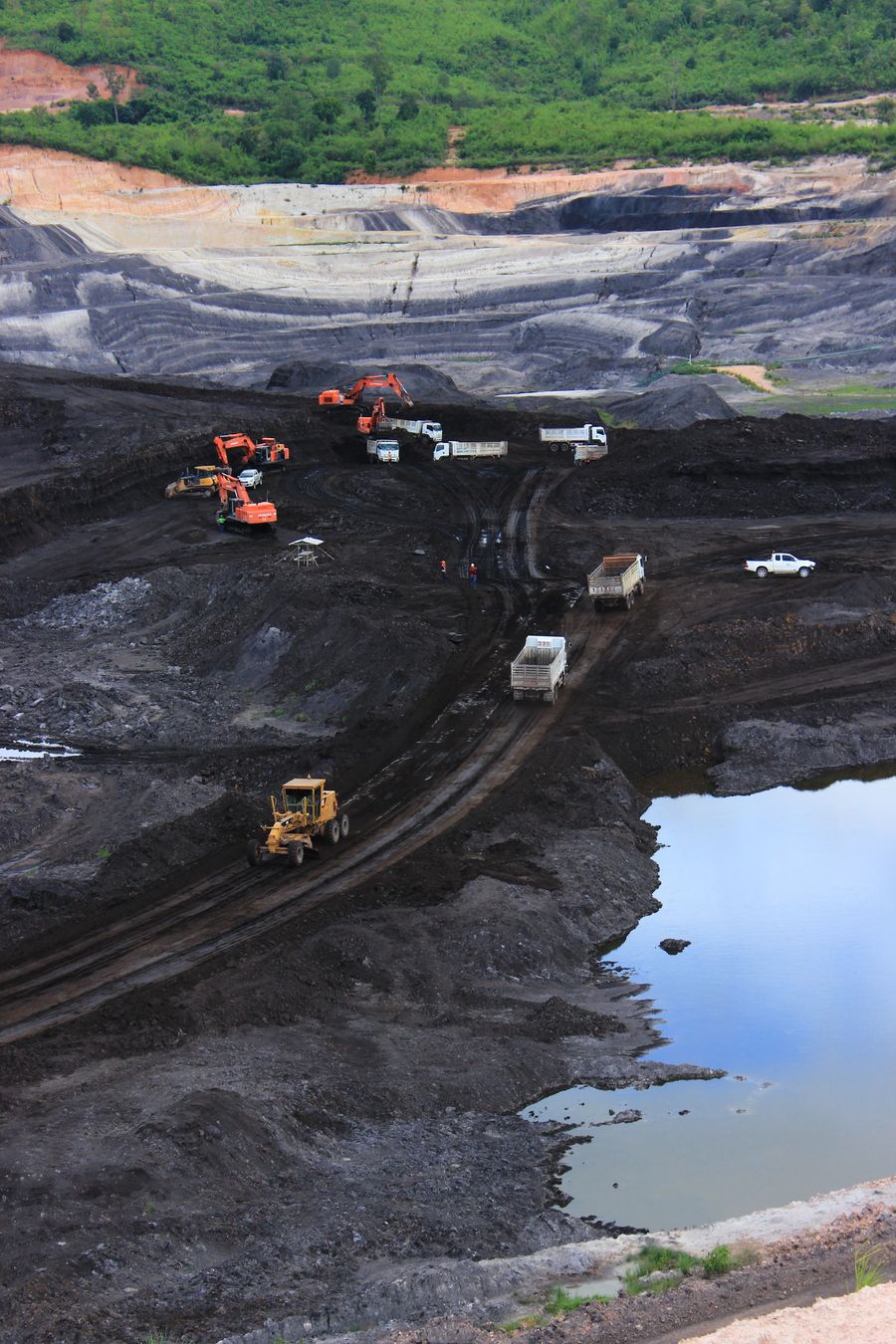 Aerial view of an open-pit mining operation with haul trucks