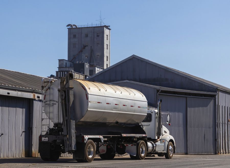 Bulk tanker truck at a warehouse, representing the Cross-Border & FMCG division