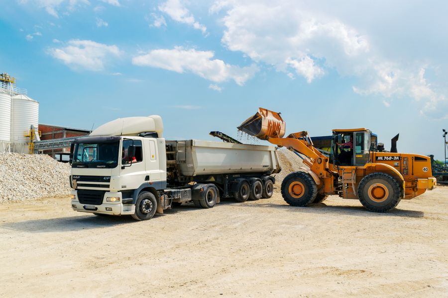 Truck being loaded with bulk aggregate, representing the Agricultural & Industrial Bulk division